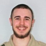 Headshot of Will Middleton smiling against a plain background