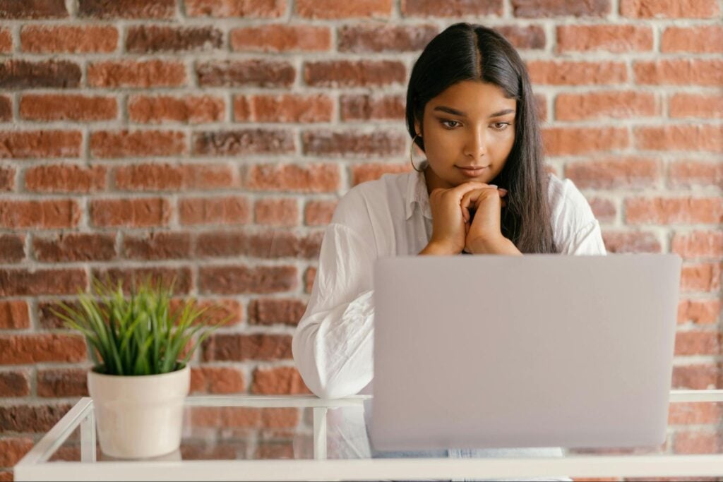 Professional completing an online continuing education course on a laptop.