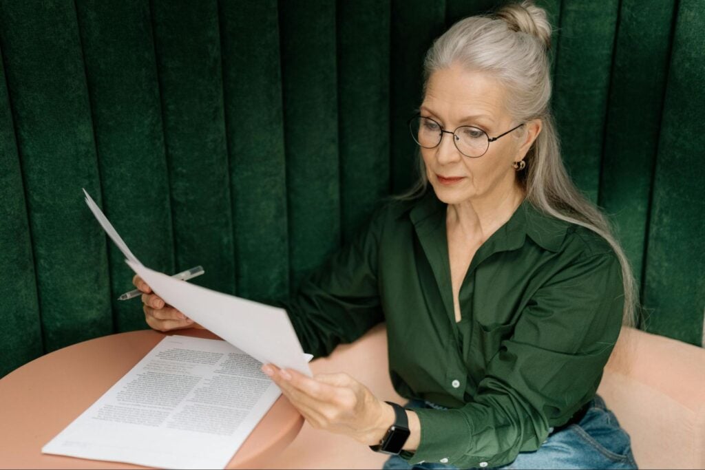 Professional reviewing certification documents as part of continuing education requirements.