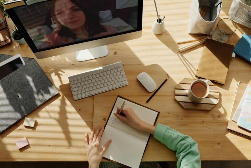 Learner taking notes during a live online training session.