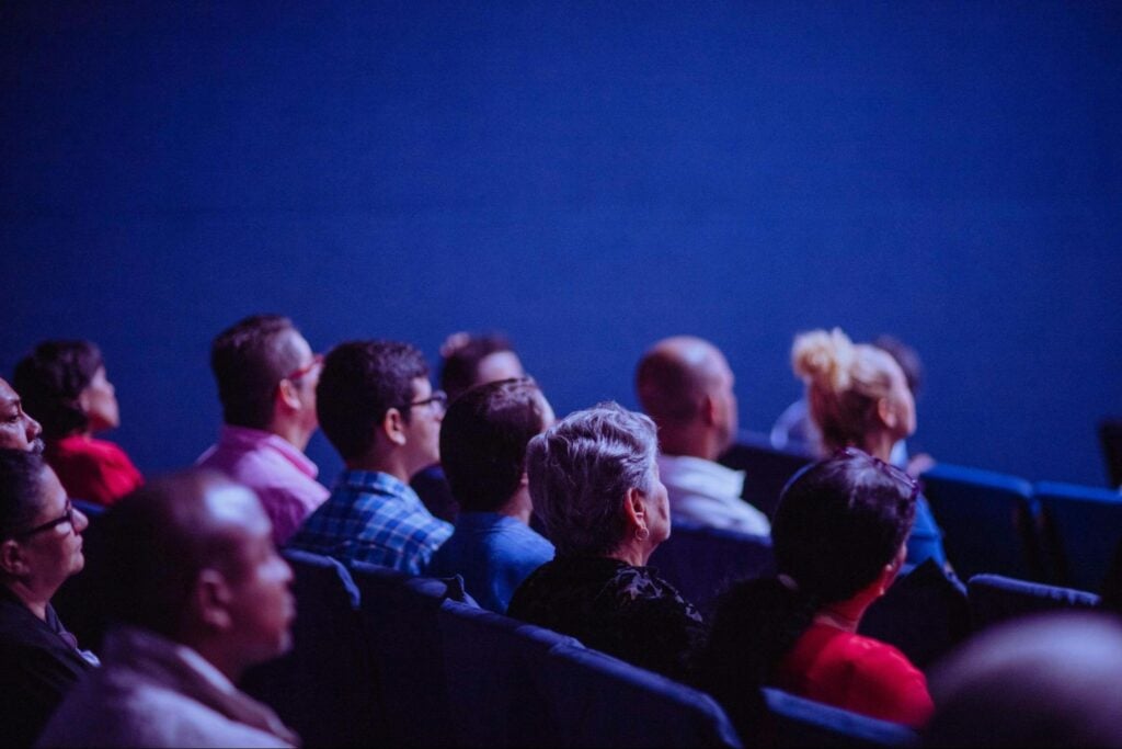 Professionals attending an in-person continuing education conference or seminar.